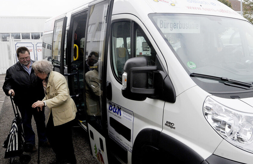 Seniorin mit Busfahrer vor Bürgerbus